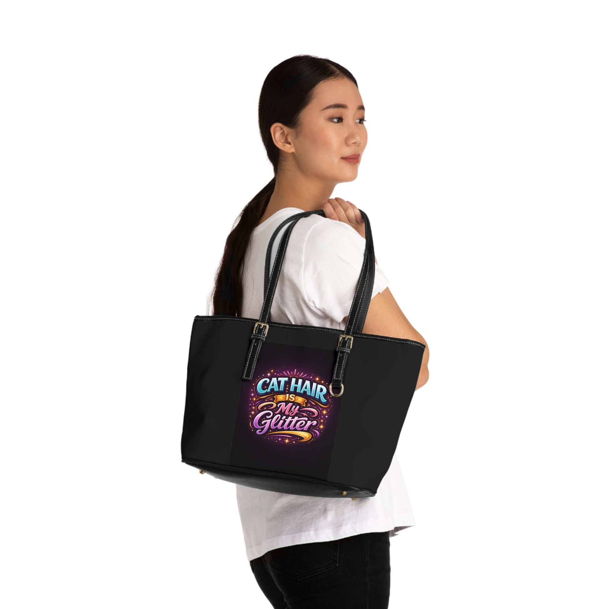 Woman holding a black tote bag with colorful text design on a white background