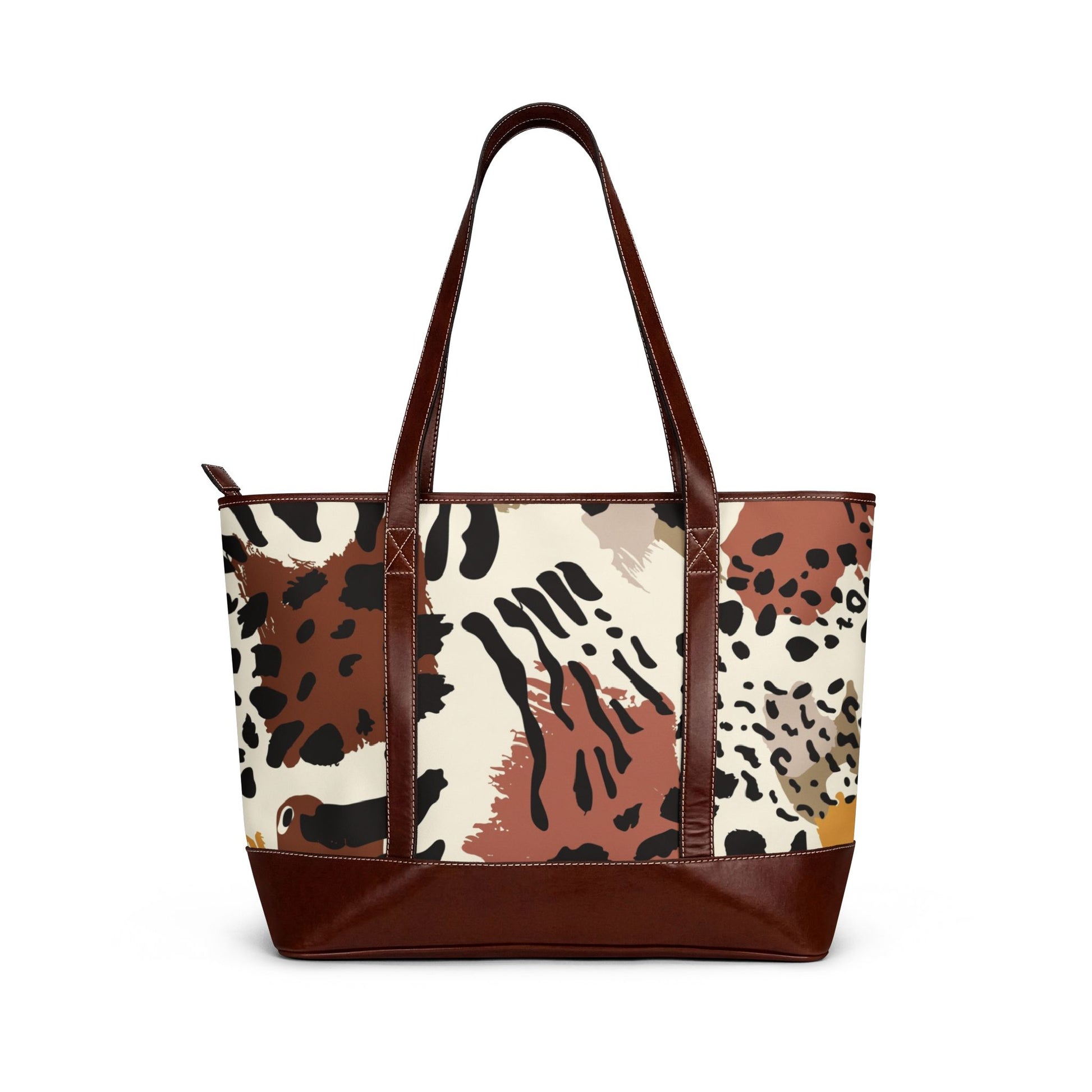 Large tote bag with a mixed animal print design in neutral tones, featuring brown shoulder straps and a wide brown base, shown against a plain background.