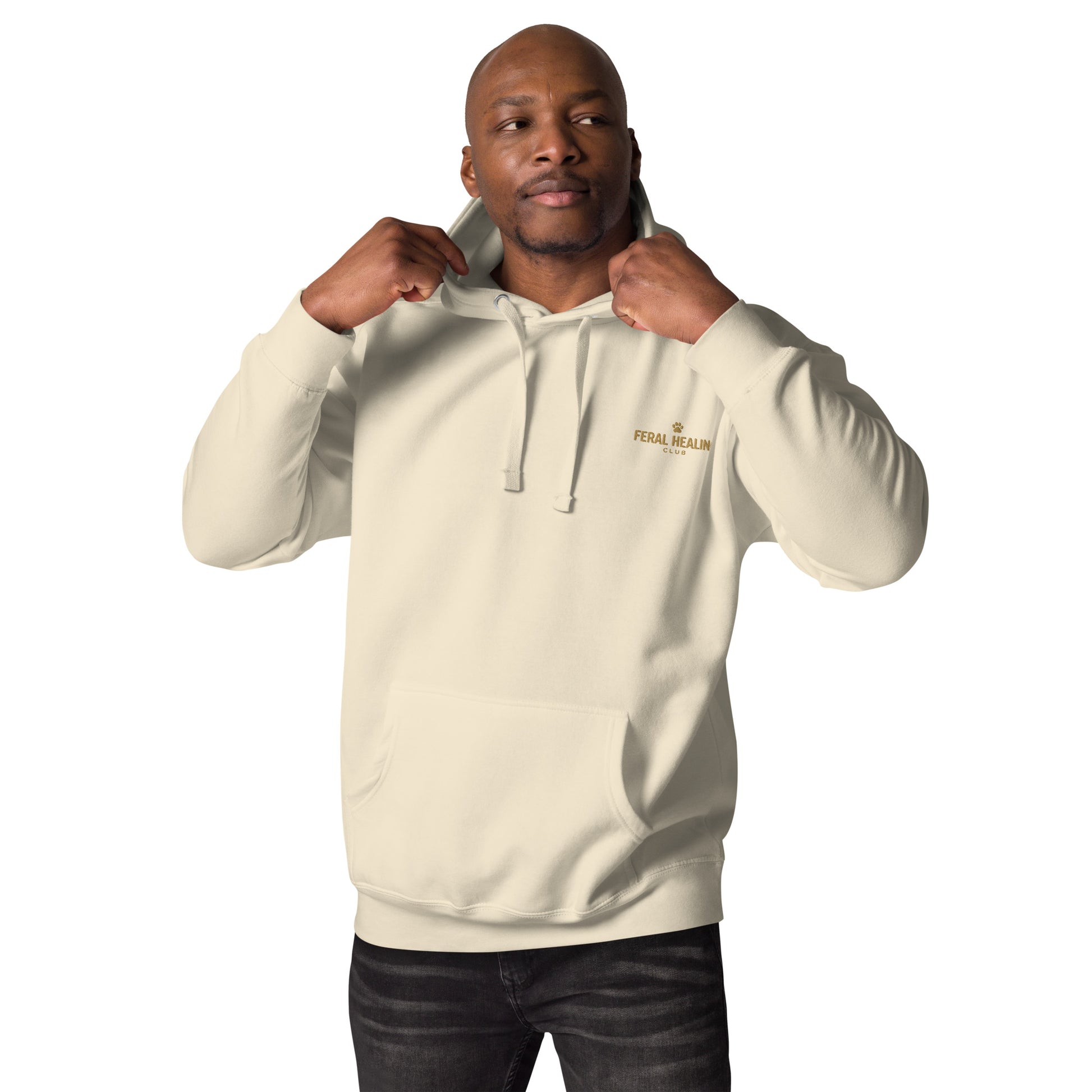 Man wearing a beige hoodie with a logo on a white background